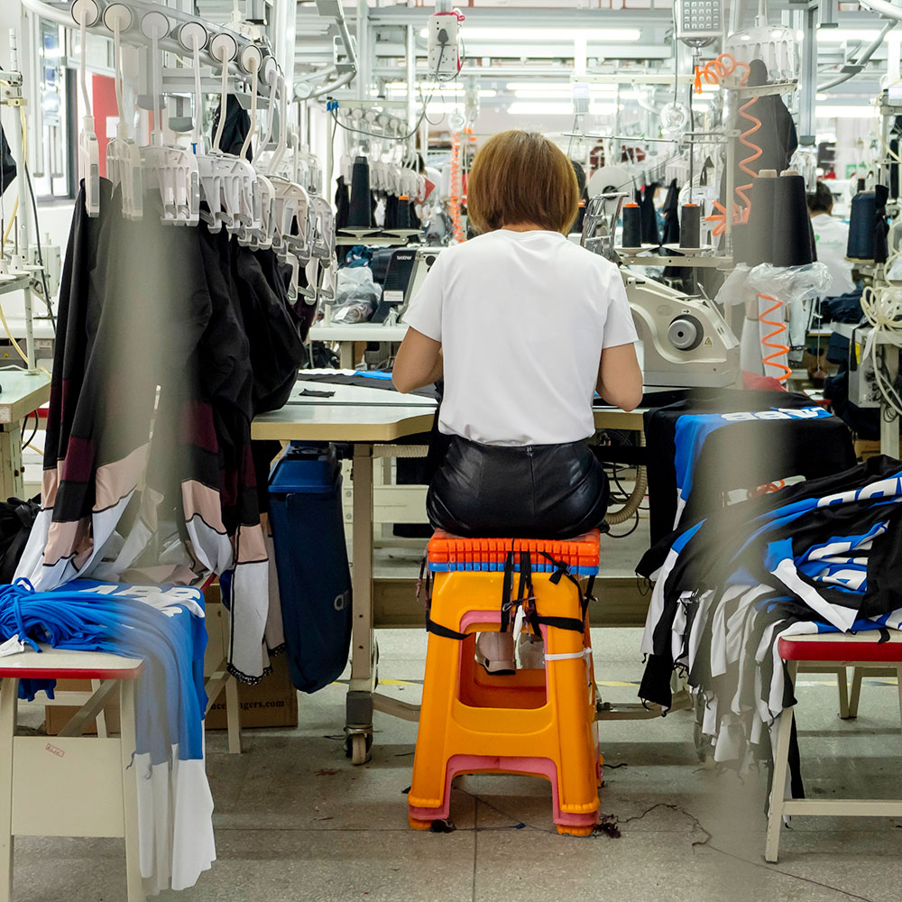 Detail of employee working in Chinese clothing factory